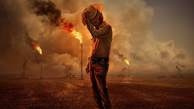 alt="Promotional image for Landman showing a lone oil worker surrounded by burning oil rigs in West Texas"